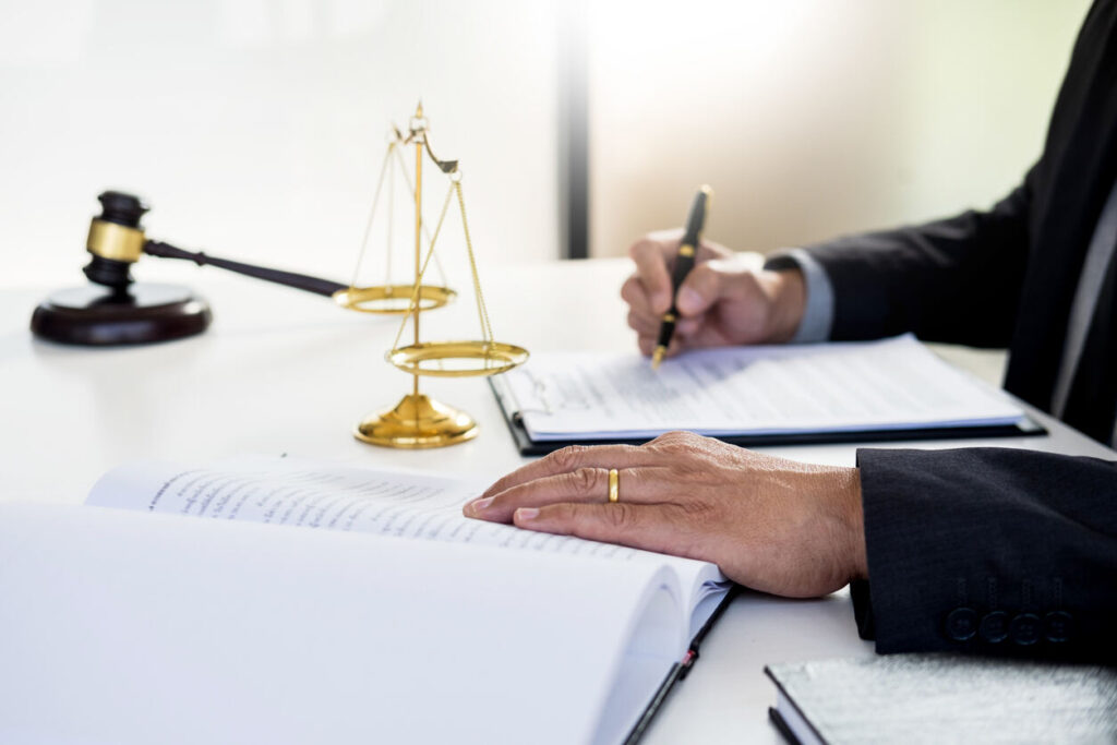 Lawton lawyer writing and gavel on the top of the table