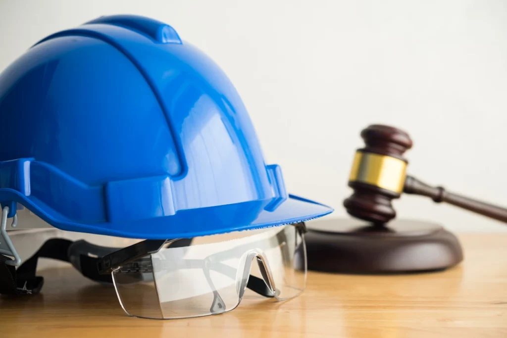 Blue hard hat and gavel representing helmet protection in law